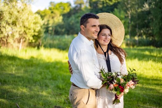 nice portrait of beautiful and young groom and bride outdoors