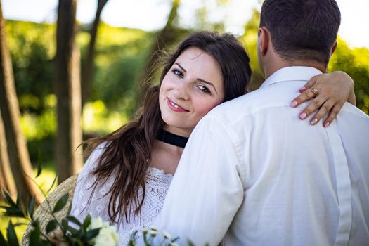 nice portrait of beautiful and young groom and bride outdoors