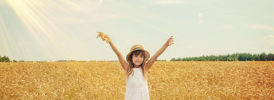 A child in a wheat field. Selective focus.