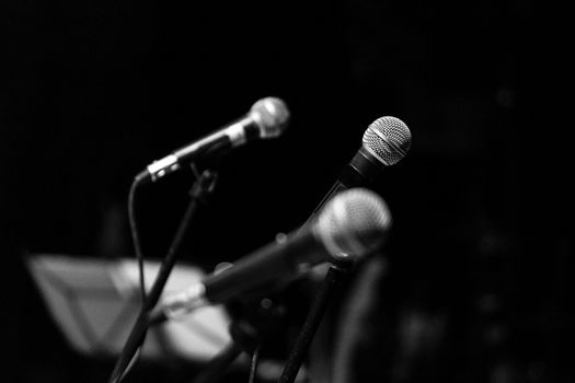 Three microphones used during a musical concert.