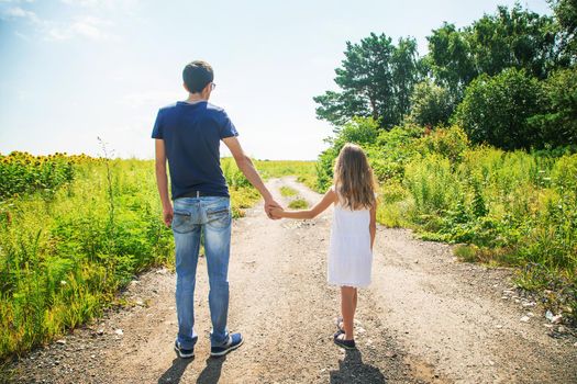 Father and daughter walk holding hands. Selective focus. nature.