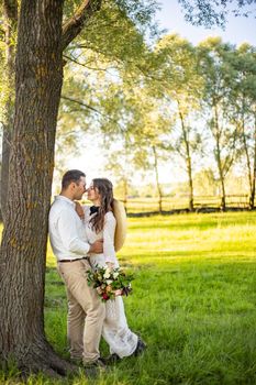 young couple bride and groom are walking on a walk in the forest. wedding day concept. romantic day. portrait of newlyweds in love.