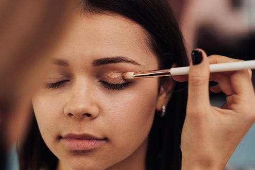 Close Up Make Up Artist Working with Client Eyelid, Young Woman at Procedure in Beauty Salon