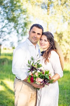 nice portrait of beautiful and young groom and bride outdoors