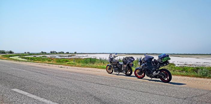 motorcycles parked on the side of the road during a trip to Camargue near Lake Sale