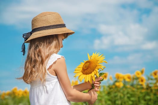 A child in a field of sunflowers. Selective focus.