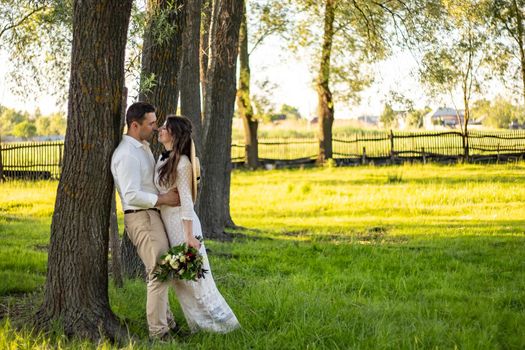 nice portrait of beautiful and young groom and bride outdoors