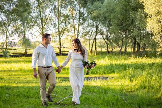 nice portrait of beautiful and young groom and bride outdoors