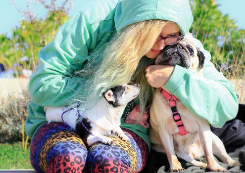 A girl hugs with love their animals.