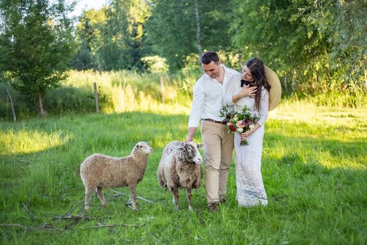Wedding on the sunset. Bride and groom in boho style.Rustic wedding in the style of boho at the ranch.