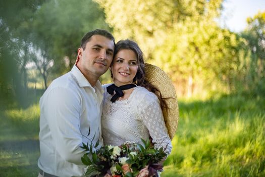 Romantic, young and happy caucasian couple in stylish clothes traveling together in the beautiful countryside nature. Love, relationships, romance, animal care, happiness concept.