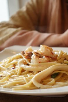 plate of sea food pasta on table .