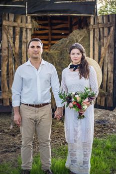 nice portrait of beautiful and young groom and bride outdoors