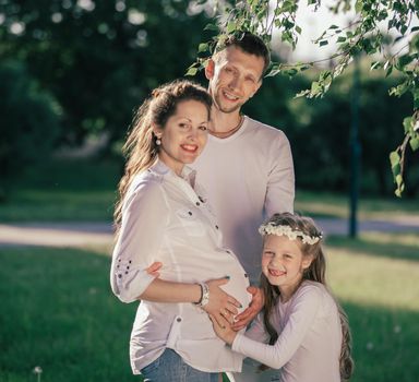 portrait of a happy pregnant woman with her family. the concept of family happiness