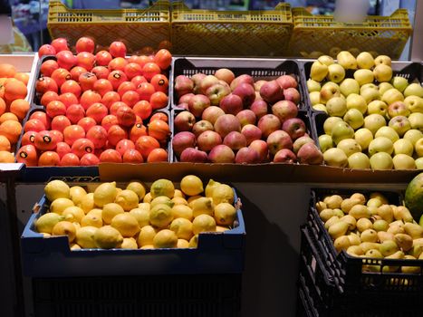 Coloful photo of plastic crates with different fruits at a market store