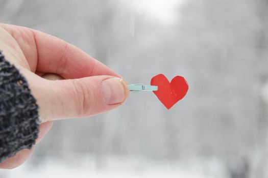 Creative winter background with paper heart. Love winter idea.