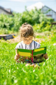 child reading a book in nature. Selective focus. nature.