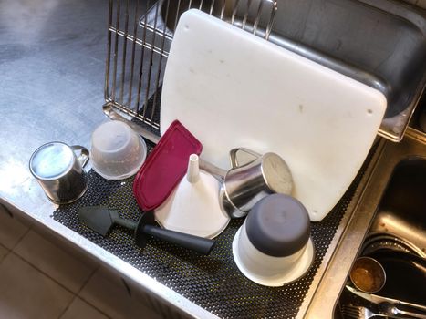 Top view of clean kitchen utensils on the sink in a kitchen of a restaurant