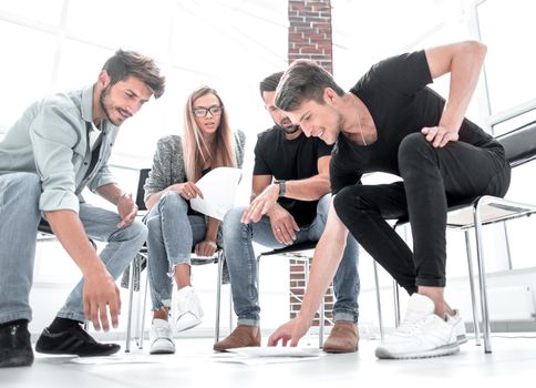 Businessman passing agreement to the business partner in conference room. Group of businessmen and businesswomen working together.