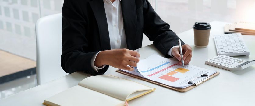 Business woman using calculator for do math finance on wooden desk in office, tax, accounting, statistics home accounring concept.