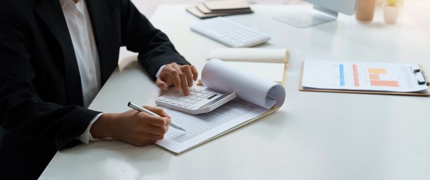 Close up view of bookkeeper or financial inspector hands making report, calculating or checking balance. Home finances, investment, economy, saving money or insurance concept.