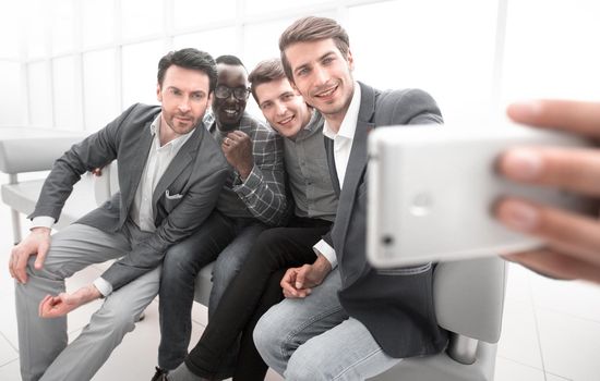 business colleagues take selfies in the office of the business center.photo on memory