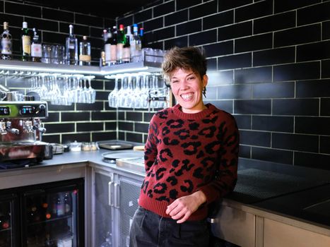 Portrait of a female manager of a restaurant with a modern look and sort hair in the kitchen