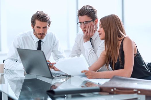 business team looking closely at the laptop screen. people and technology