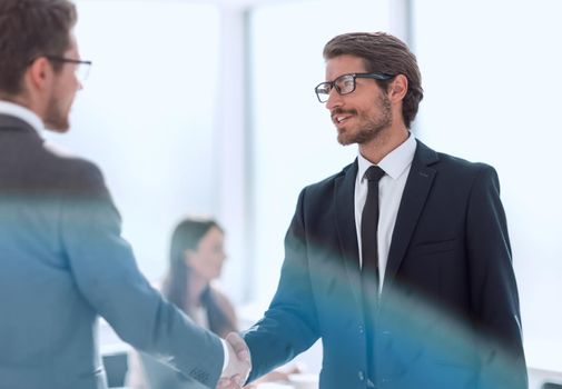 business people shaking hands standing in the office. concept of cooperation