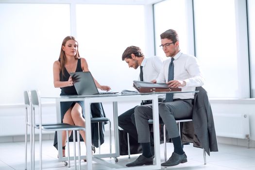 serious employees browsing online information on a laptop. photo with copy space