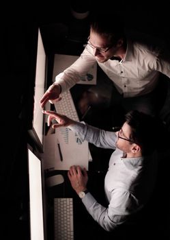 top view .business colleagues discussing information on the computer screen.business and technology