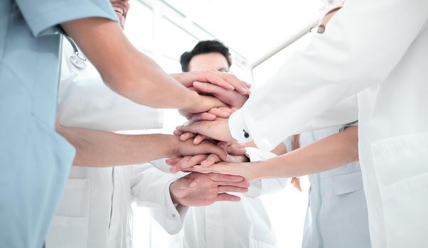 Large business team showing unity with their hands together