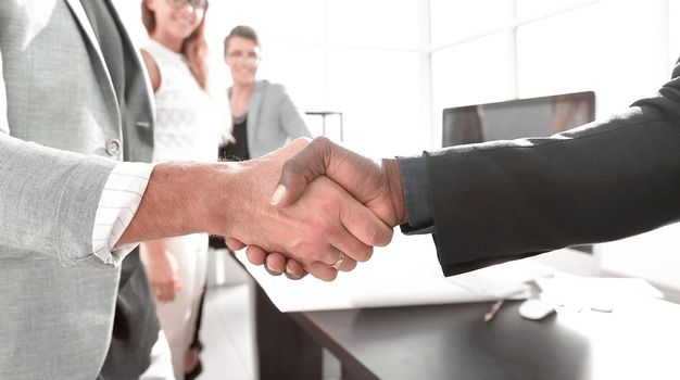 close up.architect and customer shaking hands in the main office.the concept of successful cooperation