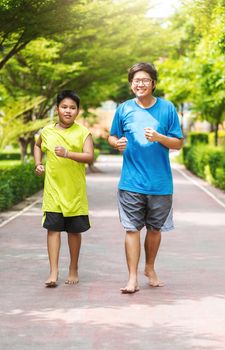 Asian couple of brother run together in park