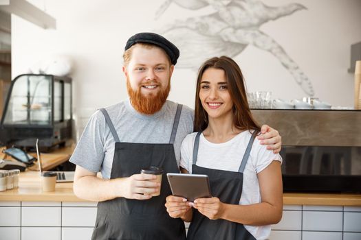 Coffee Business Concept - Portrait of small business partners standing together at their coffee shop