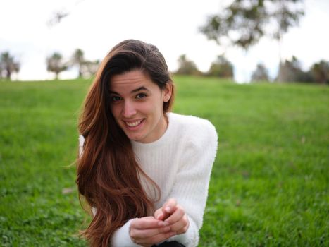 Front view of a young woman looks shyly at the camera because the boy she likes has caught her looking at him. Concept of emotions.