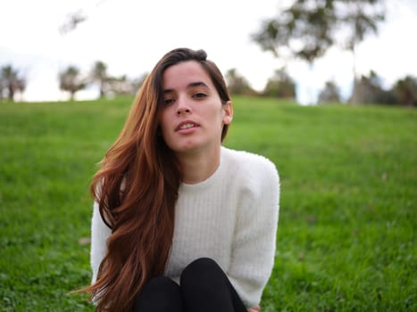 Front view of a young girl in love looking at the boy she likes in the park. Concept of emotions.