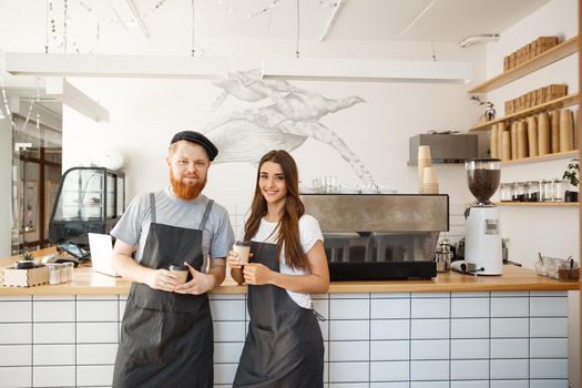 Coffee Business Concept - Portrait of small business partners standing together at their coffee shop