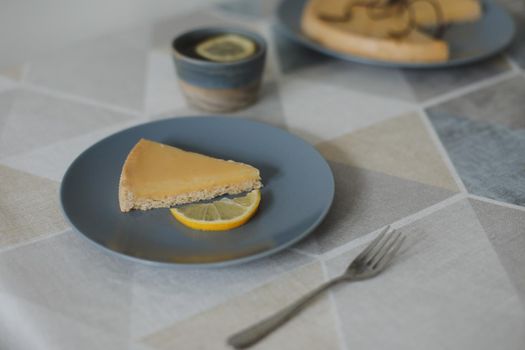 Closeup of yummy lemon tart with tea set and lemons