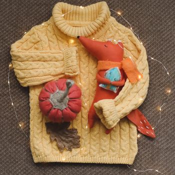 cozy autumn composition with a funny handmade toy fox