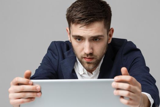 Business Concept - Portrait handsome stressful business man in suit shock looking at work in laptop. White Background.