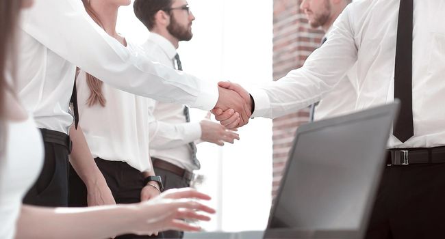 handshake business people in a modern office.concept of partnership
