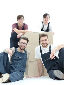 Cheerful workers with stacked boxes isolated on white.