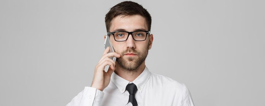 Lifestyle and Business Concept - Portrait of a handsome businessman serious talking with mobile phone. Isolated White background. Copy Space.