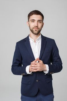 Business Concept - portrait young successful businessman posing over dark background. Copy space.