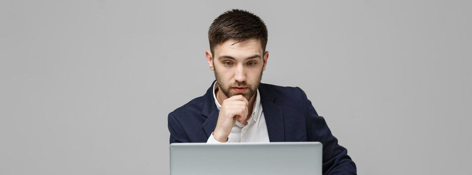 Business Concept - Portrait handsome stressful business man in suit shock looking in front of laptop at work office. White Background