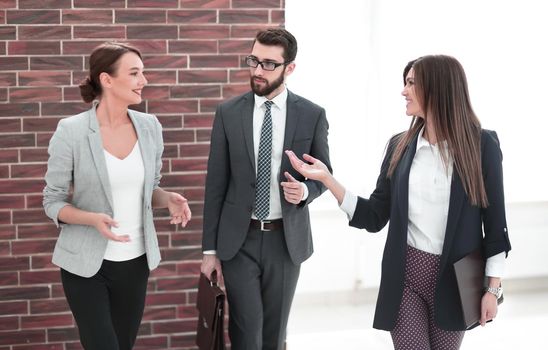 business woman talking to colleagues standing in the office.photo with copy space