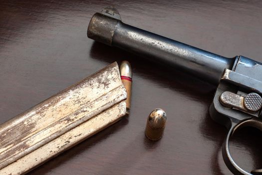 close-up of gunpoint and bullets on table. Weapons and ammunition. 