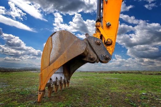 Industrial background. Digger bucket close-up. Construction excavator bucket.