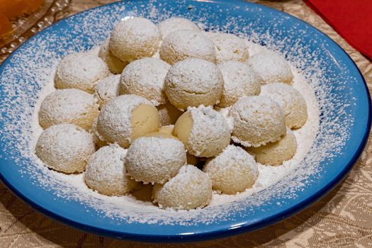 Homemade cookies with powdered sugar on a plate. Close up.